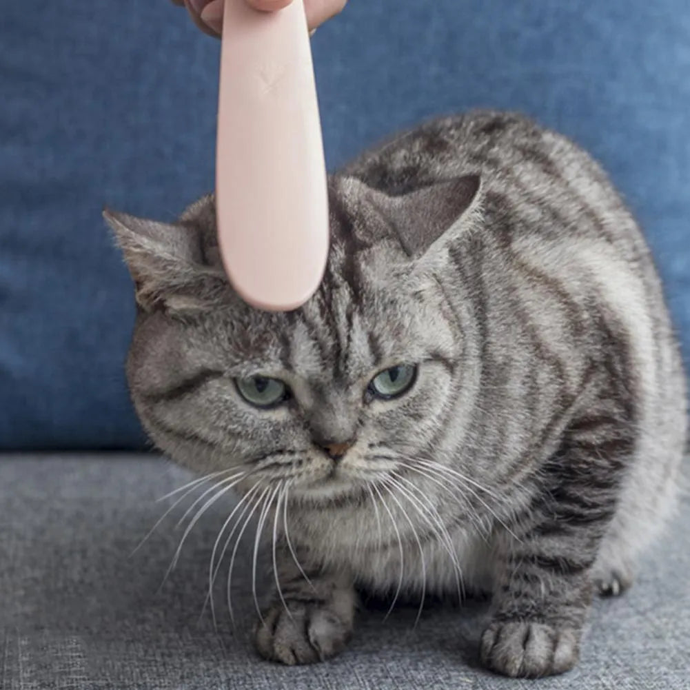 Grey and pink ABS plastic cat grooming comb with tongue-mimicking massage design