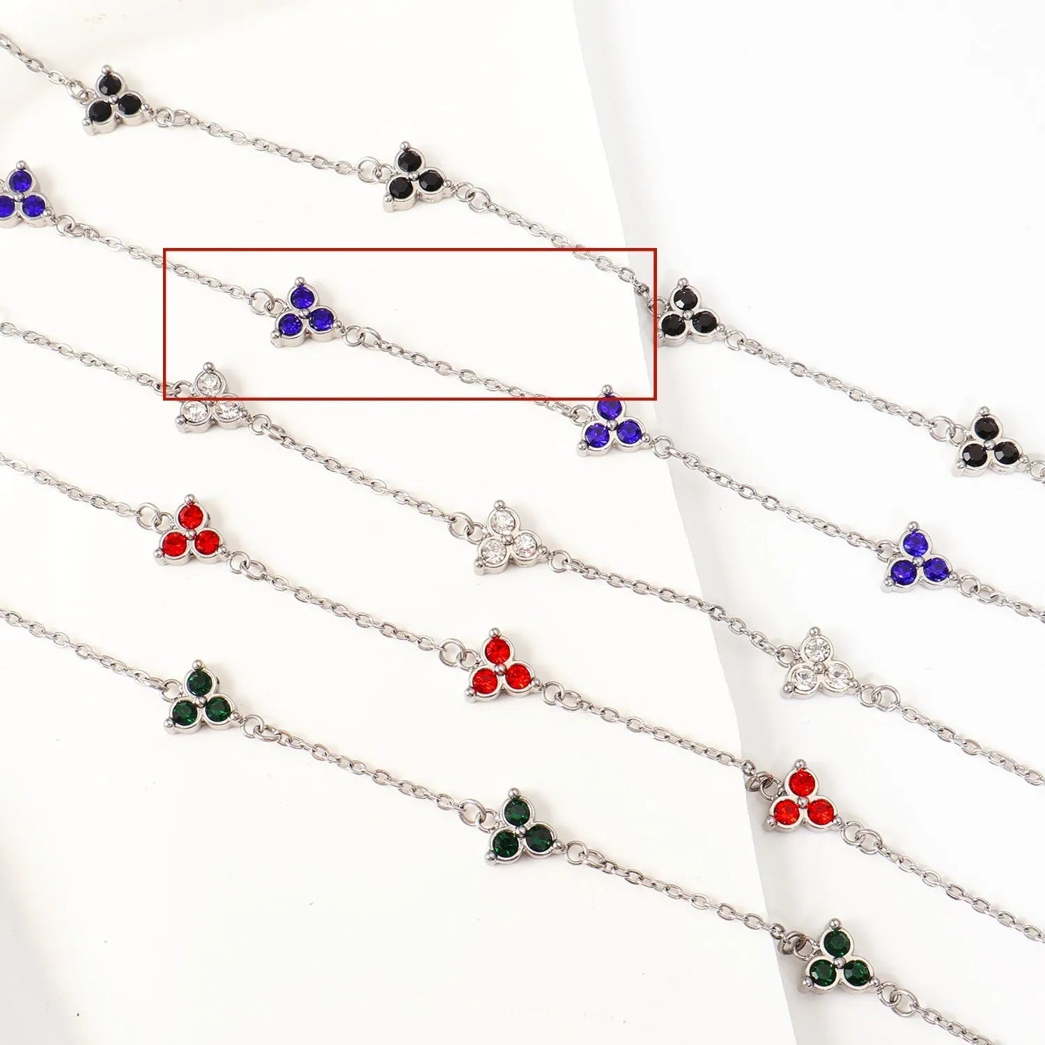 Women's stainless steel geometric bracelet with triangle elements and coloured stone settings