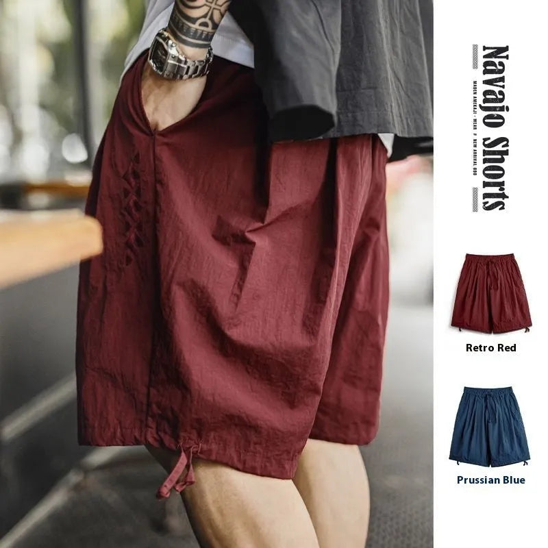 Prussian blue men's loose fit beach shorts with embroidery on lightweight nylon fabric.