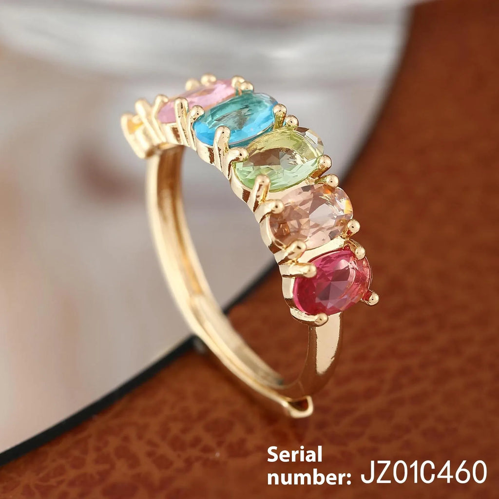 Adjustable gold women's ring with zircon accent on white background