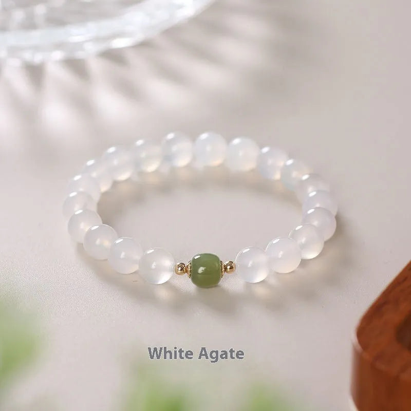 Handmade natural white agate crystal bracelet with cinnabar detail in 6mm or 8mm bead size.