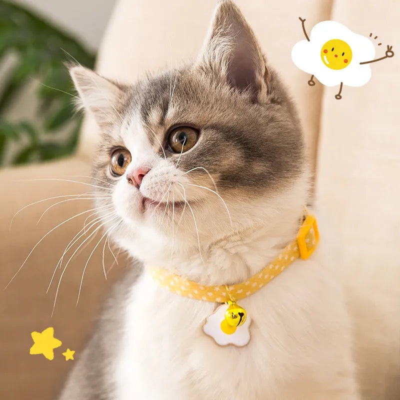 Adjustable green cat collar with a metal bell and a matching bow tie for small pets.