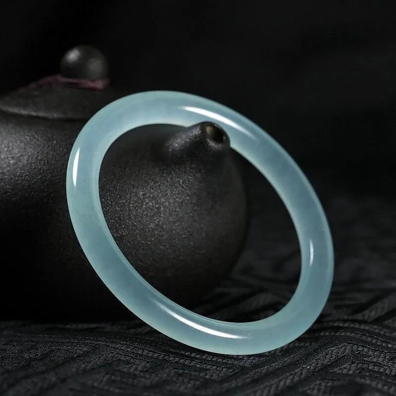 Women's jade bracelet with floating flower design in ice-like emerald appearance
