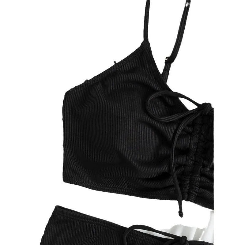 Black women's high-waist bikini with sling split design on shorts and sleeveless top.