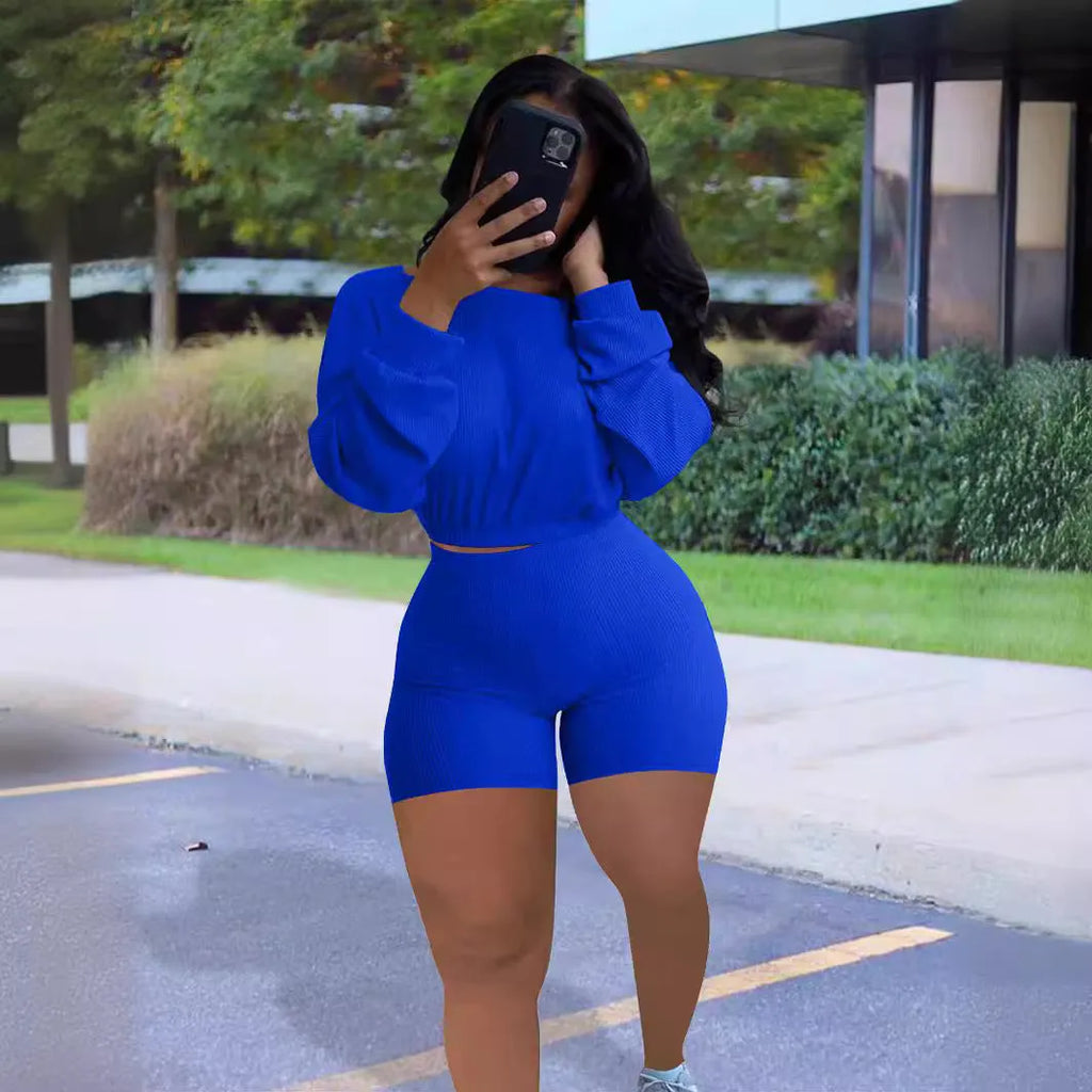 Sunken stripe solid colour off-the-shoulder long sleeve top and shorts two-piece set on a hanger.