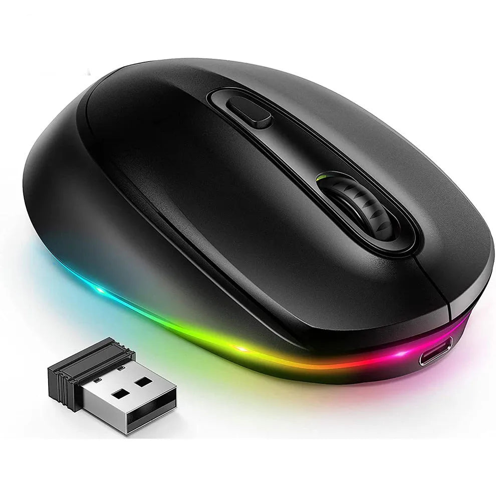 Light grey wireless computer mouse with USB charging cable on wooden desk