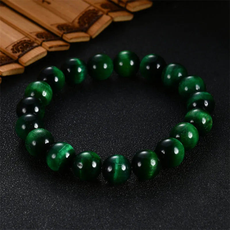 Green Tiger Eye stone beaded bracelet showing polished geometric beads on a wrist.