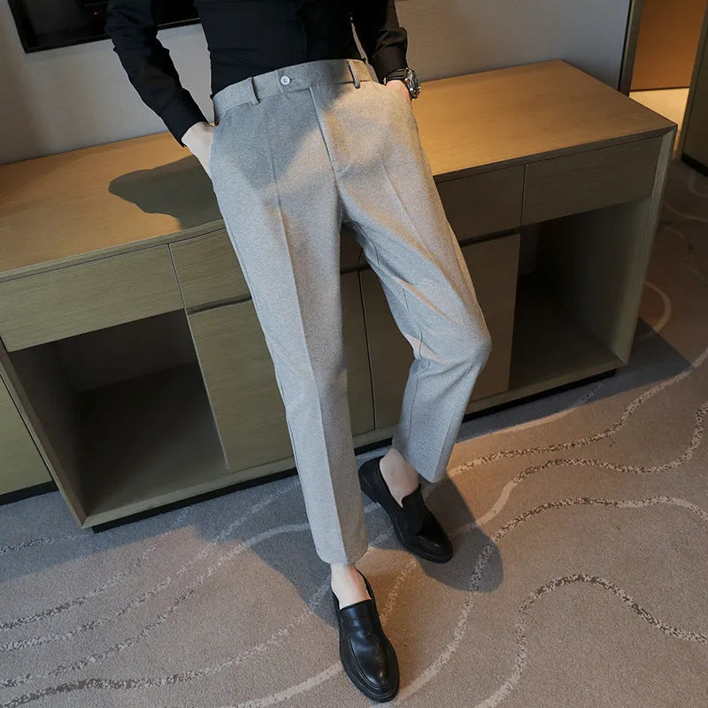 Men's brown straight-leg corduroy trousers with an elasticated waistband laid flat.