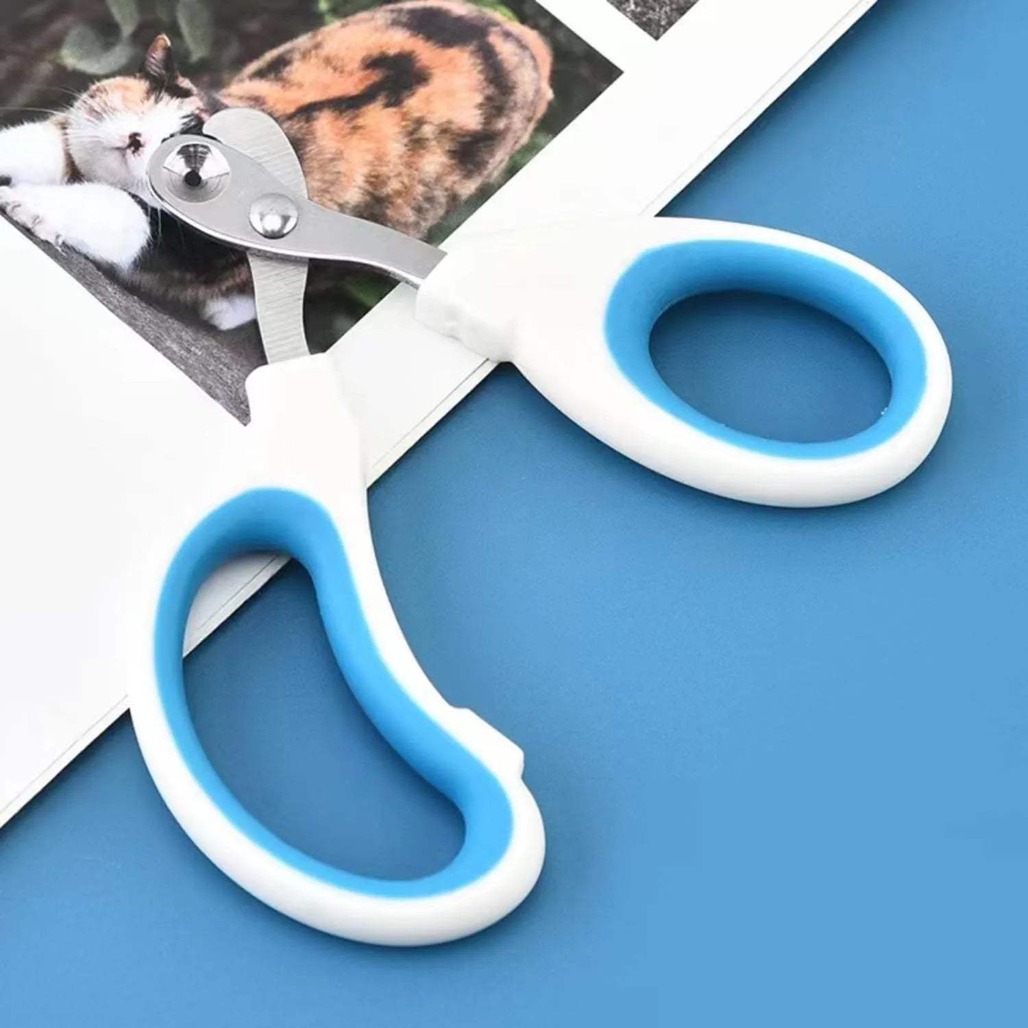 Blue cat nail clippers with a circular guide hole and non-slip handle on a white background.