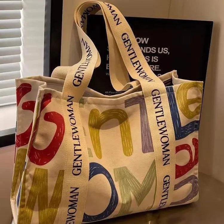 Large canvas tote bag with printed design, shown in multiple colour and pattern options.