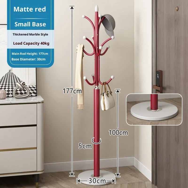 Floor-standing iron coat rack in black with vertical metal frame for hanging jackets and bags in a bedroom or hallway