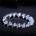 Women's white crystal ghost pyramid bracelet with ruyi symbol on wrist, showing adjustable bead sizes.