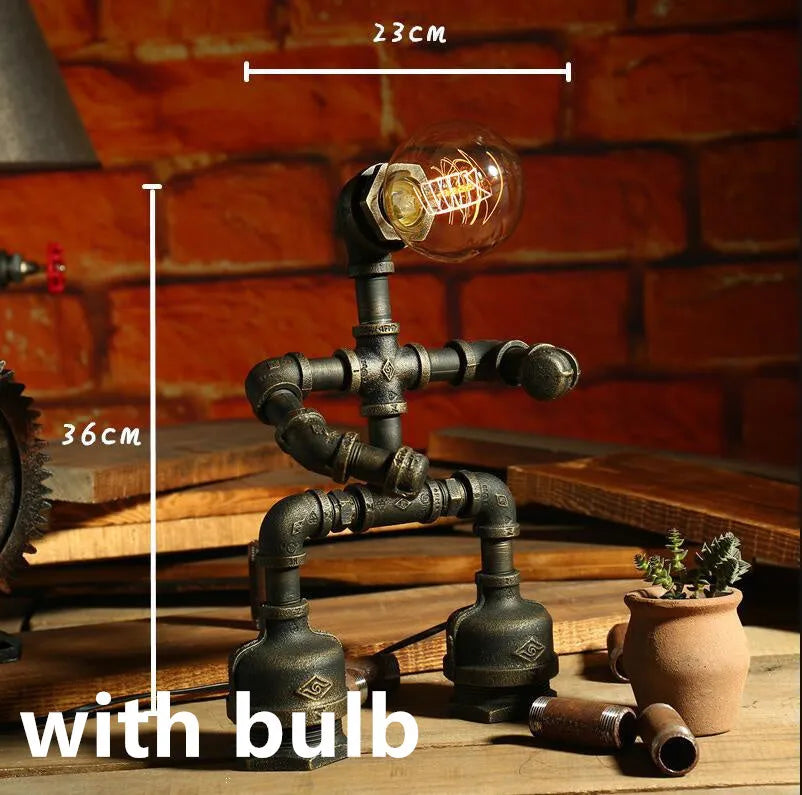 Green bronze vintage industrial iron pipe desk lamp on a wooden table.