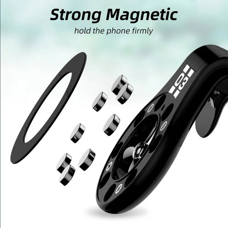 Black magnetic car phone holder clipped to a car air vent, showing adjustable paddle and fragrant slice.