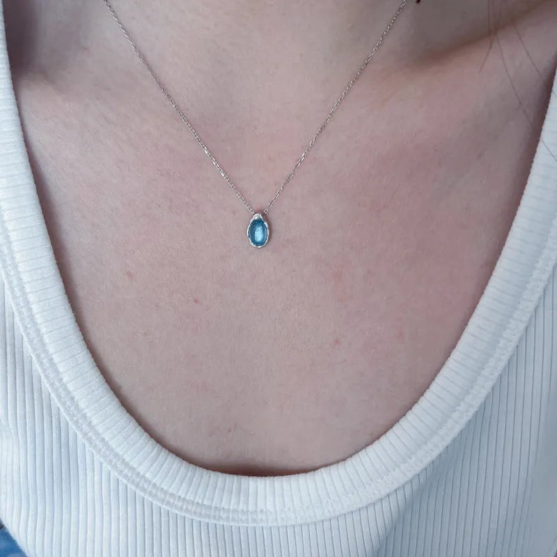 Navy blue geometric water drop pendant necklace with platinum-plated finish on adjustable chain