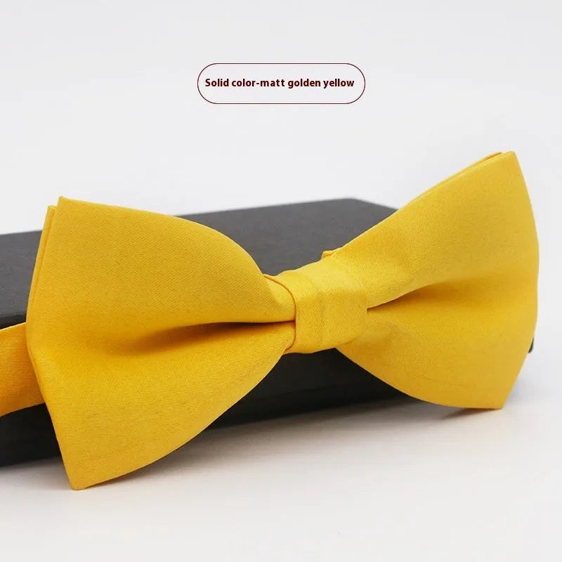 Men's flat head style polyester bow tie in a solid colour, shown with adjustable neck strap.