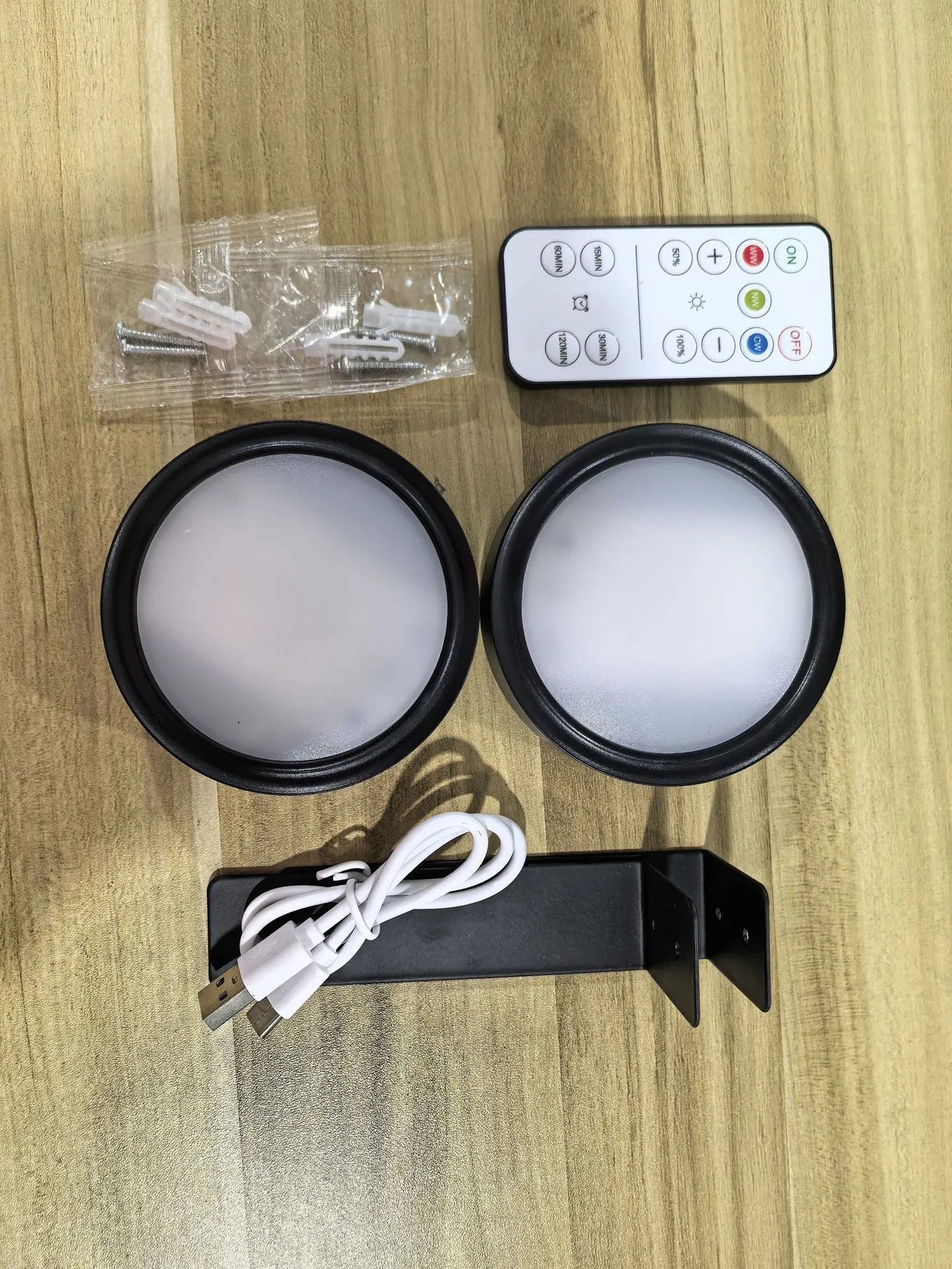Wireless rechargeable LED painting lamp with magnetic belt attached to a metal frame, remote control nearby.