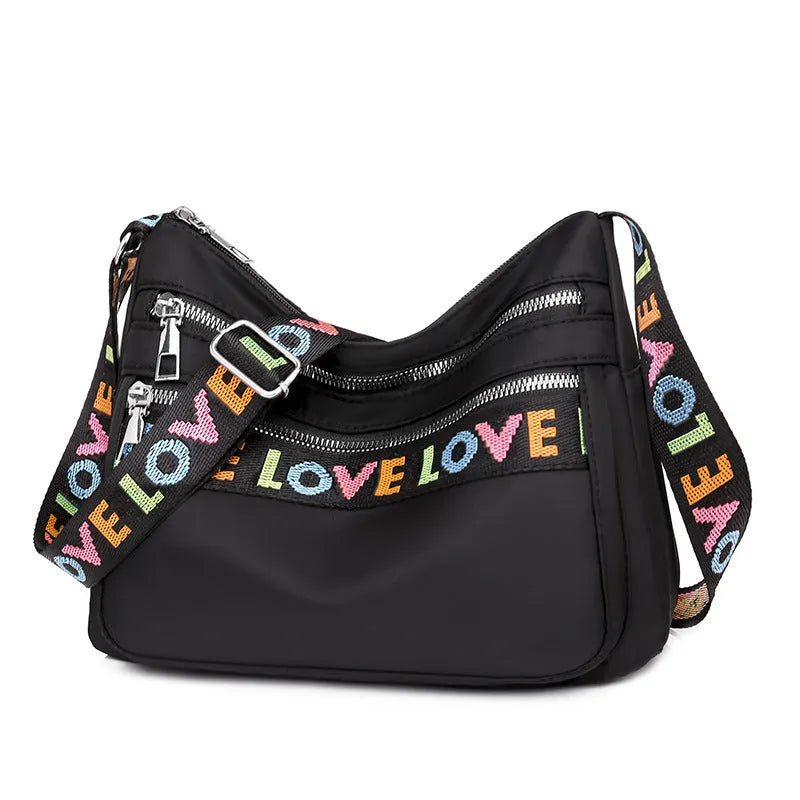 Soft oxford cloth crossbody shoulder bag with multiple pockets, letter stitching, available in black and red