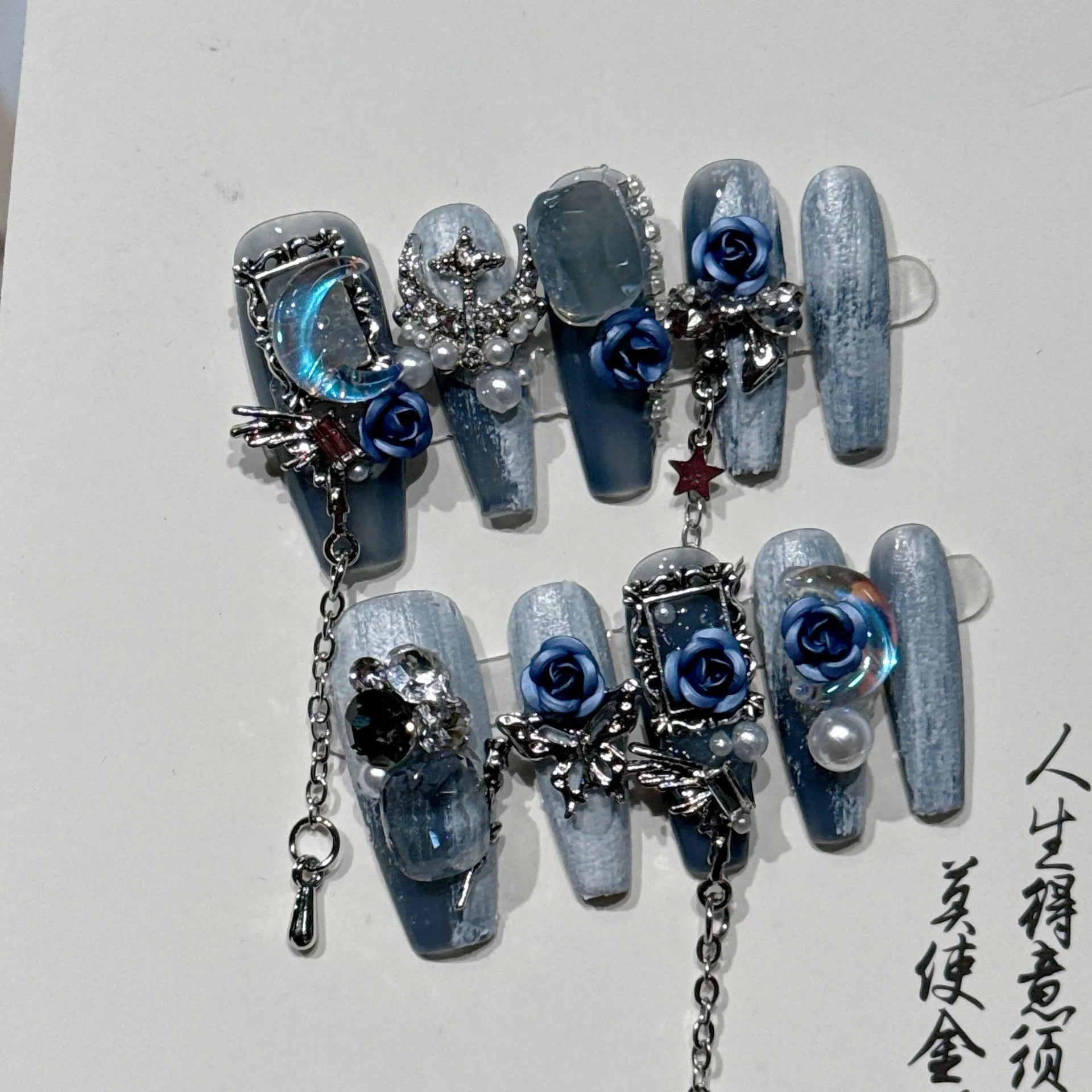 Heavy industry blue evening manicure nails with twinkling rose and flower patterns in four sizes