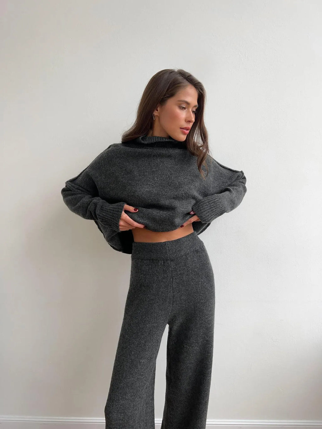 Women's dark grey acrylic sweater with side slits paired with matching trousers
