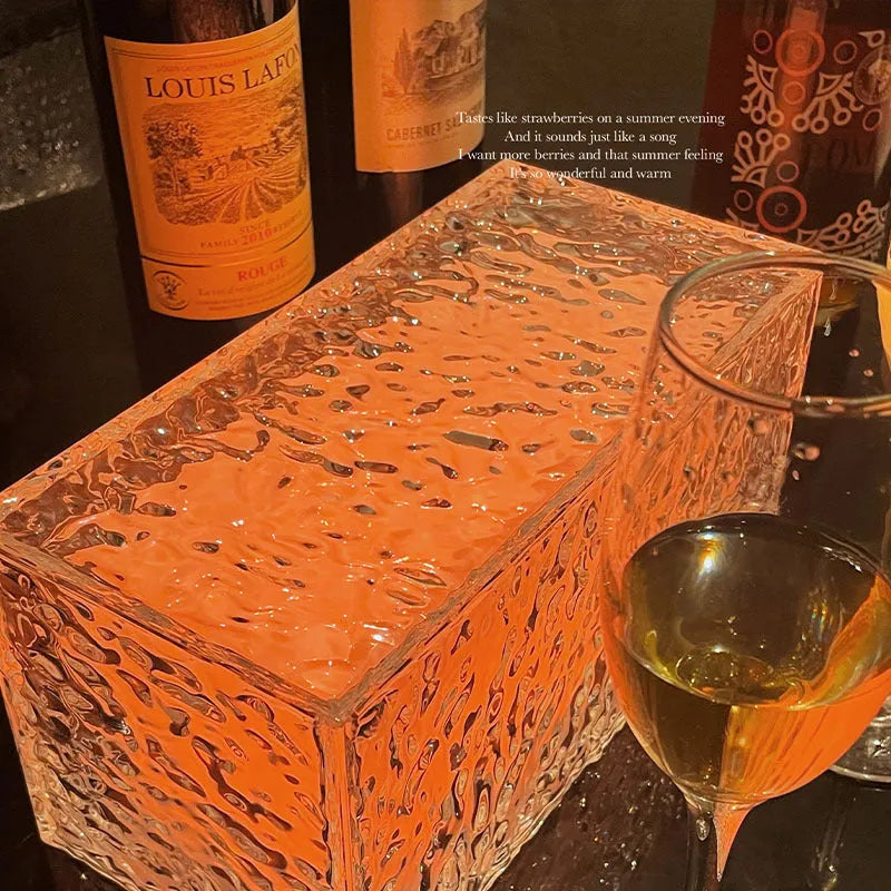 Small clear acrylic cube night light with colour-changing LED mood lighting on a wooden surface.