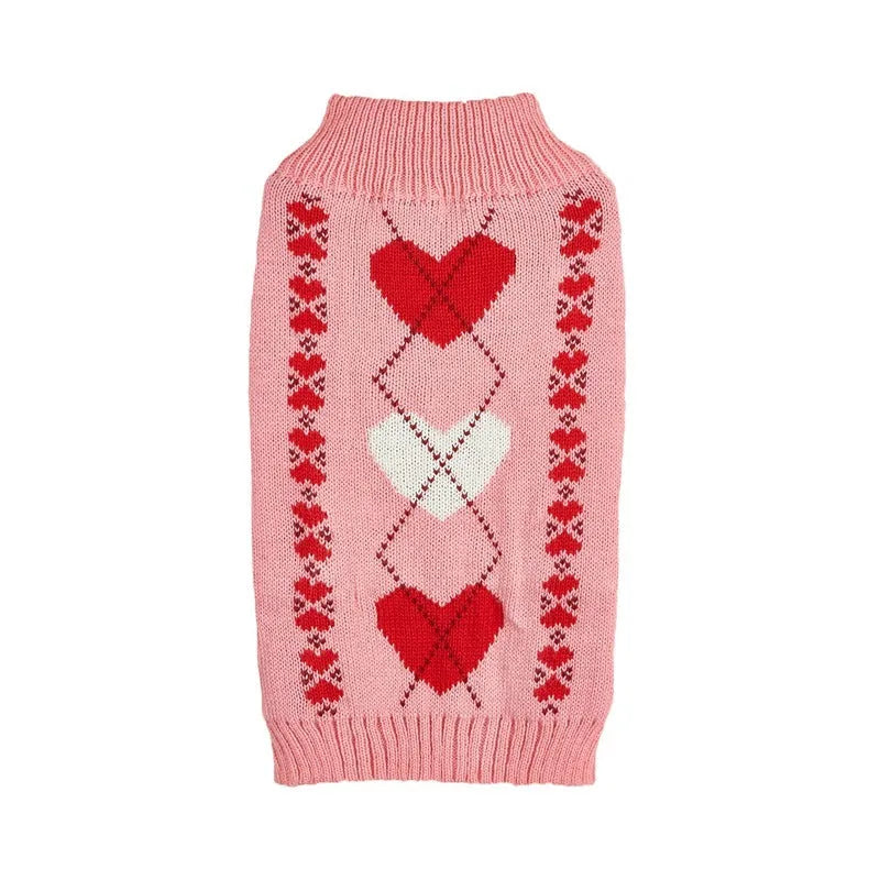 Small dog wearing a pink acrylic sweater with a bow and love heart design in ins style