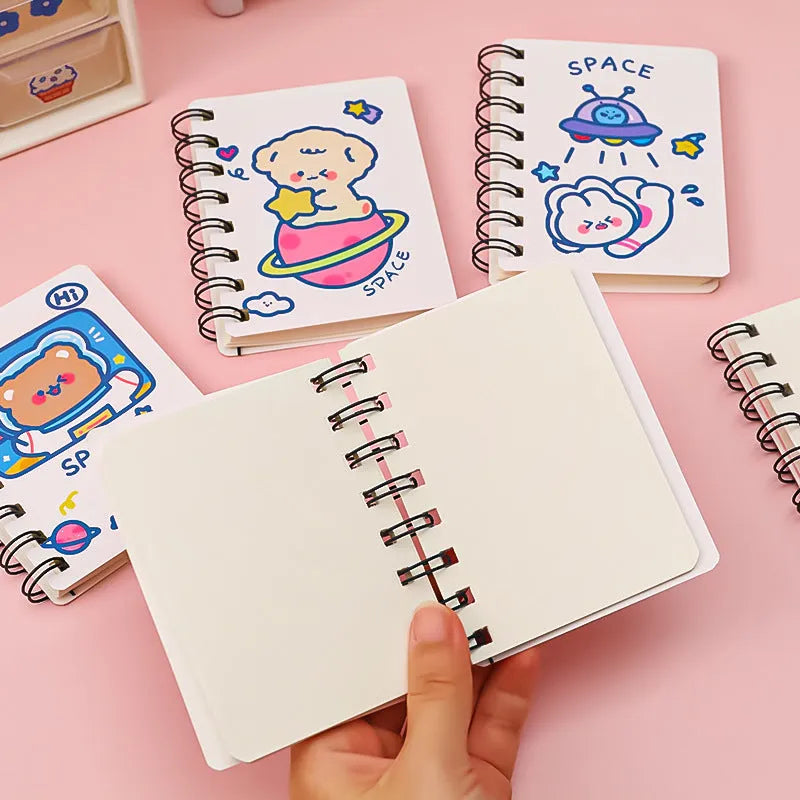 Astronaut flipped portable pocket notebook showing space-themed cover designs at 10.5 by 8 cm size