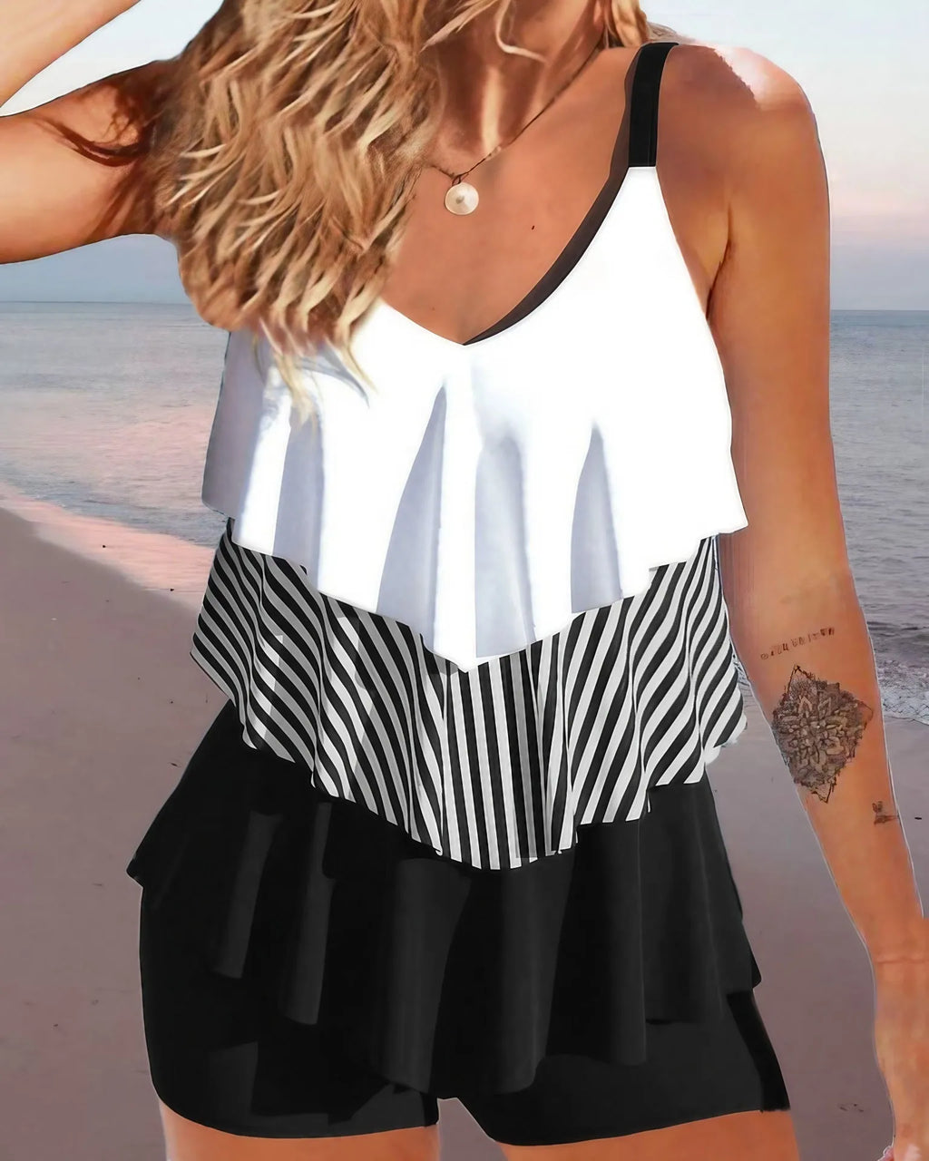Women's sleeveless backless spaghetti-strap bikini with ruffled split-side briefs in a floral print.