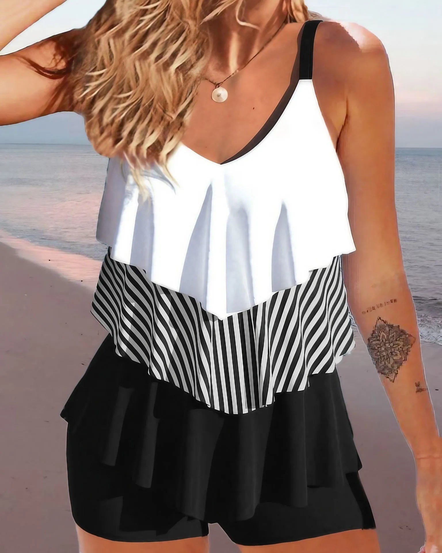 Women's sleeveless backless spaghetti-strap bikini with ruffled split-side briefs in a floral print.