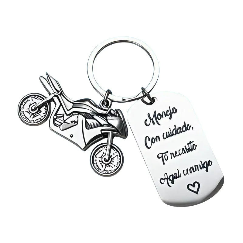 Stainless steel metal keychain on a velvet cloth, showing Motorcycle Keychain and Flannel Bag style options.