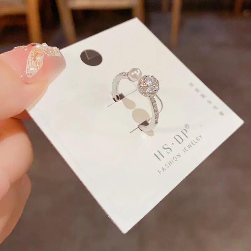Adjustable open-end pearl ring with round zircon stone in gold or silver finish