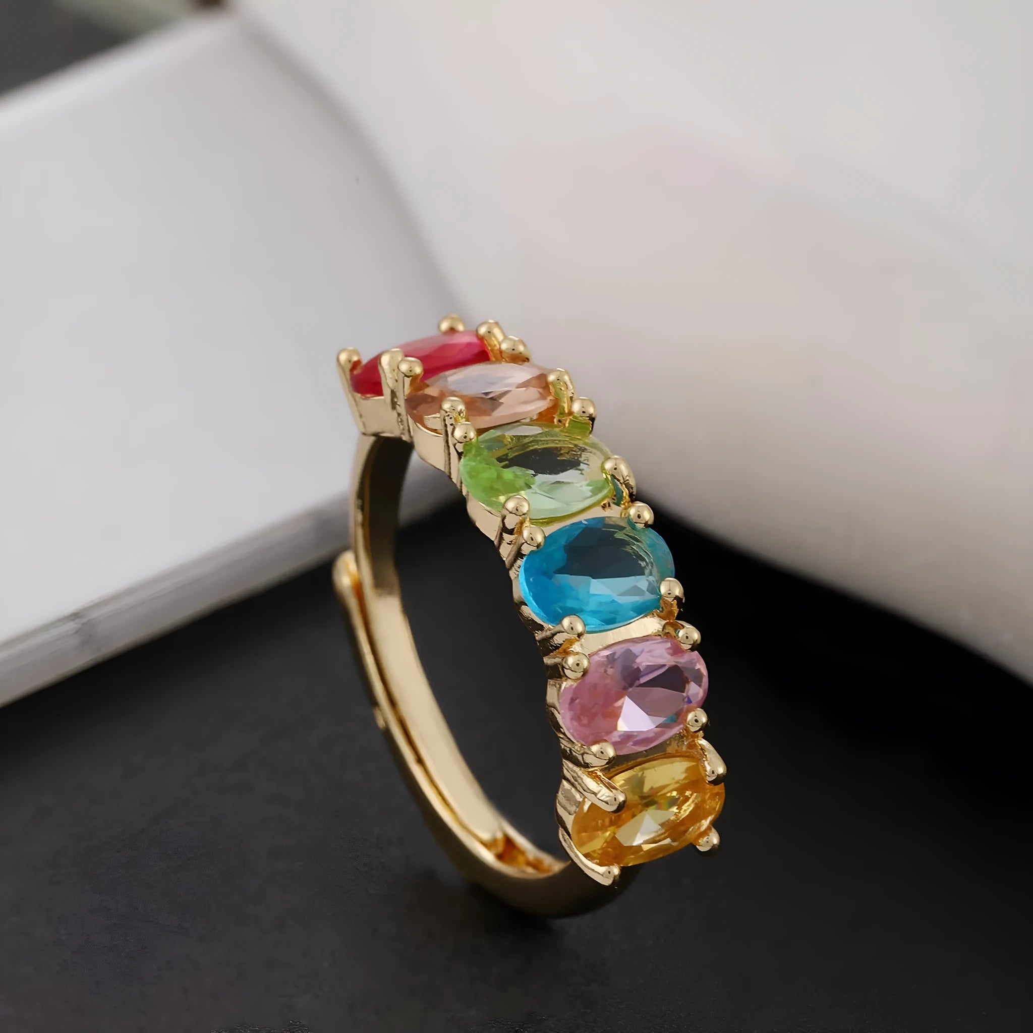 Adjustable gold women's ring with zircon accent on white background