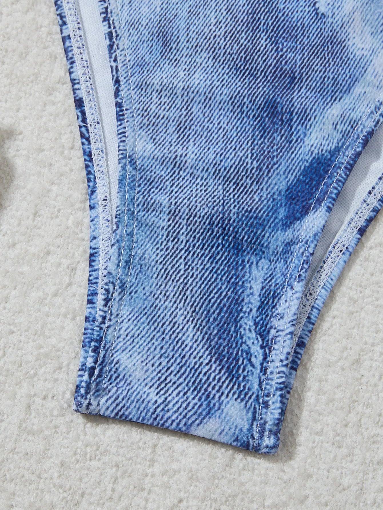 Denim blue printed women's bikini set with strap design on a model, showing front and back.
