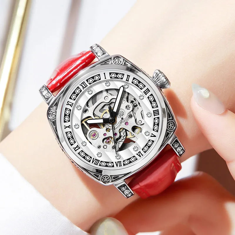 Mechanical watch with luminous hands on a leather strap, showing colour options of black, red, steel, and white dials.