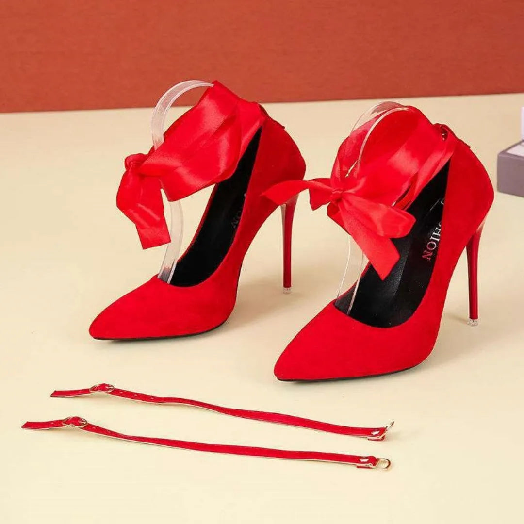 Black women's stiletto pump with thin lace strap and pointed toe on a 12cm heel.