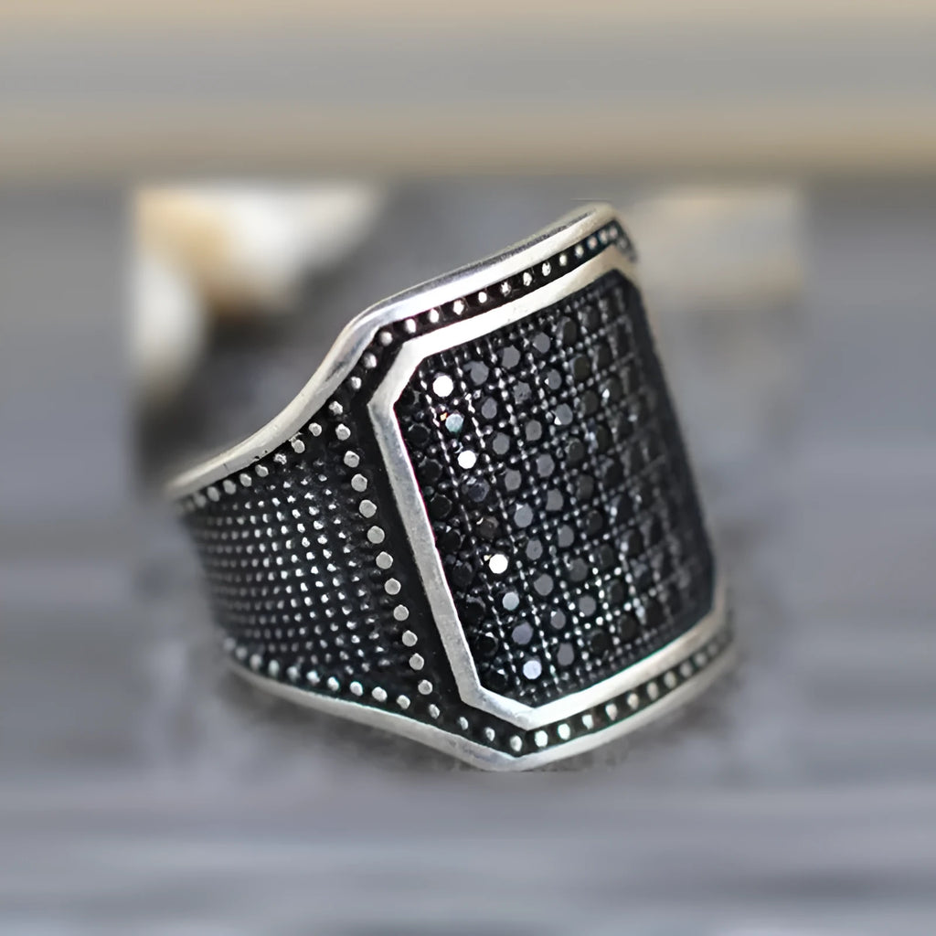 Black alloy ring with copper inlay and zircon stones, shown in a unisex European American design style.