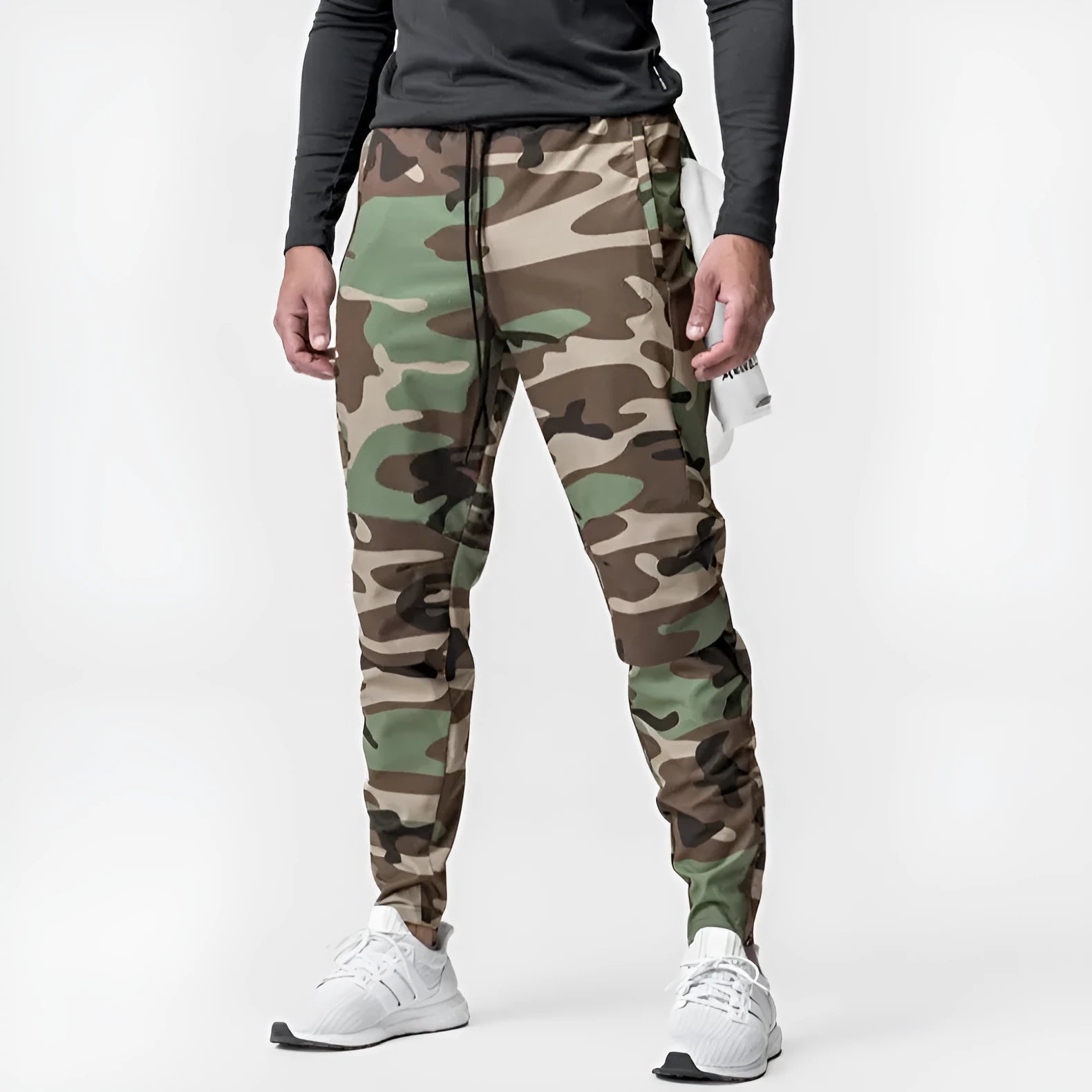 Men's grey loose-fit running pants with ankle ties on a gym floor