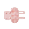 Silicone cat hair removal massage comb attached to a wall corner with rounded teeth for grooming