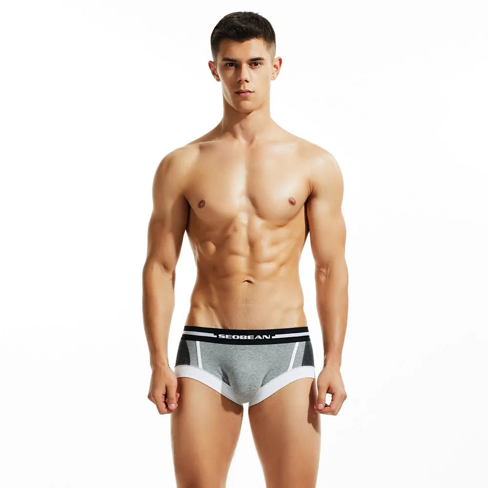 Men's low waist cotton boxers in dark blue, light grey, and red colours showing hip-lifting design