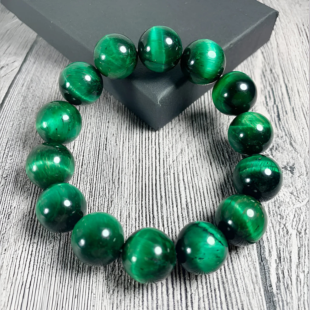 Green Tiger Eye stone beaded bracelet showing polished geometric beads on a wrist.