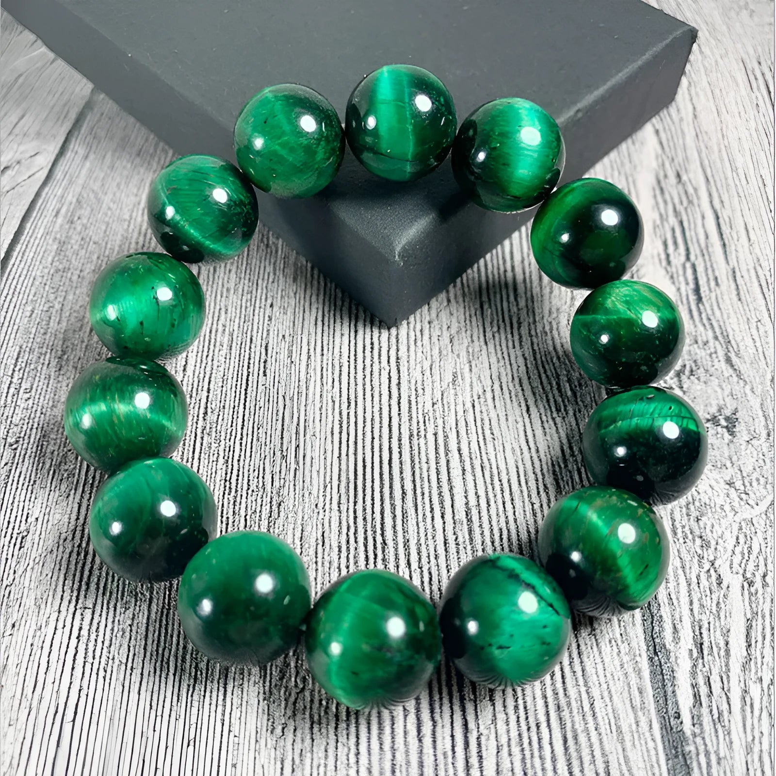 Green Tiger Eye stone beaded bracelet showing polished geometric beads on a wrist.