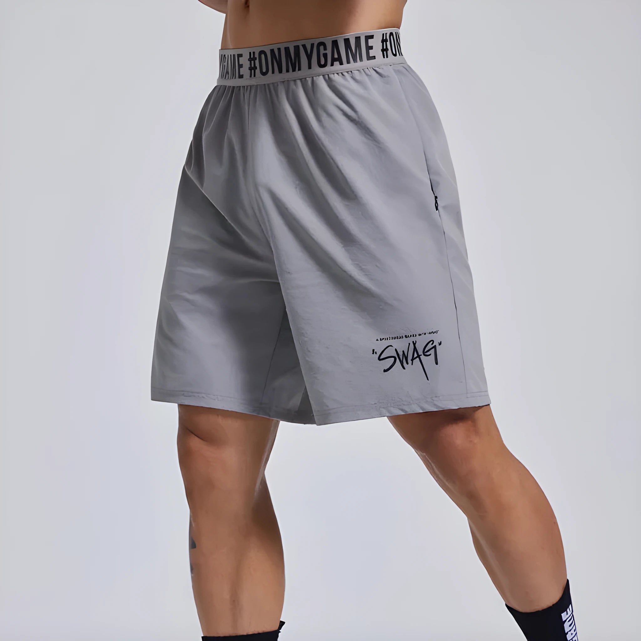 Men's loose-fit cropped sports shorts in black with elastic waist and letter details