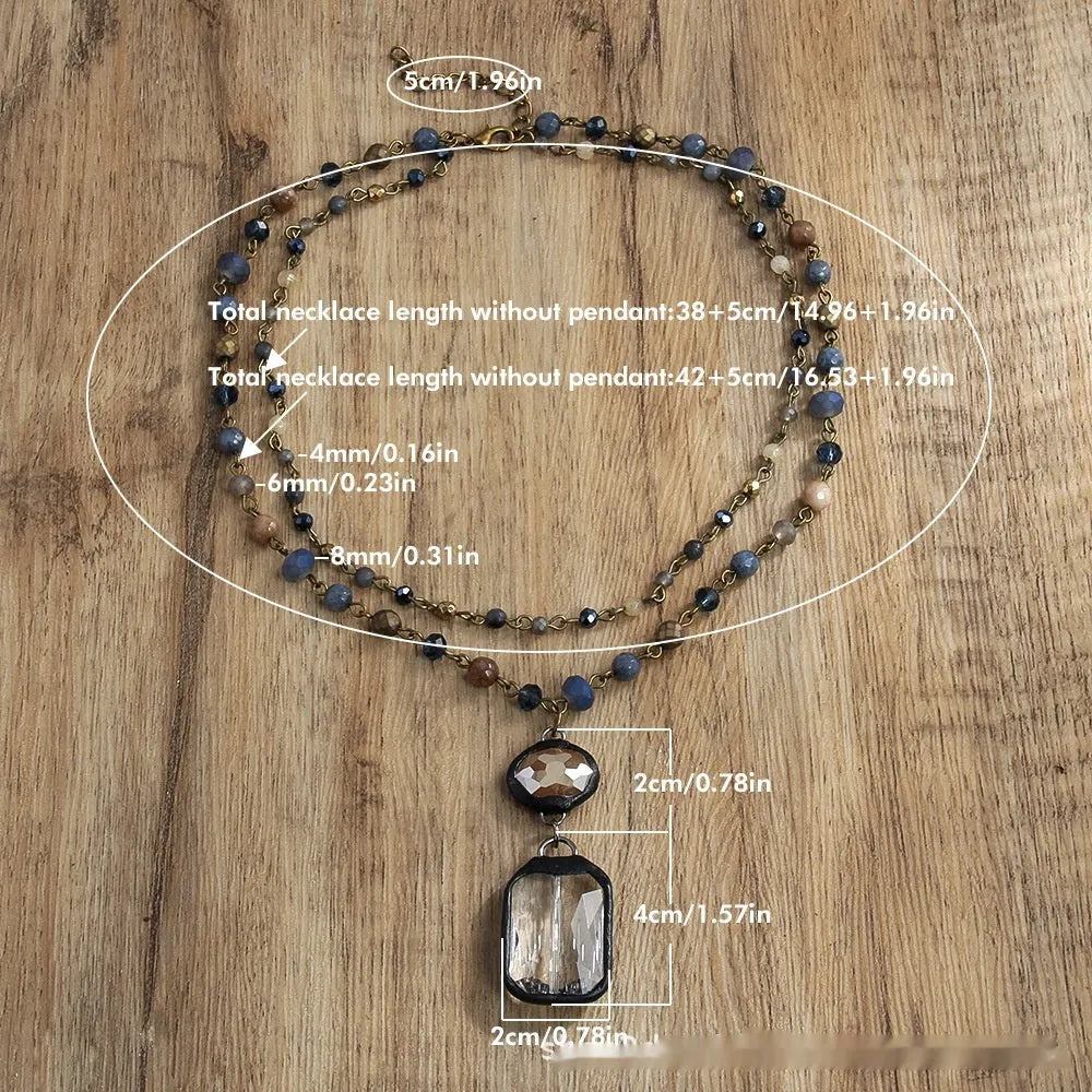 Two-layer tribal necklace with stone and glass pendants on a chain, shown in beige and blue.