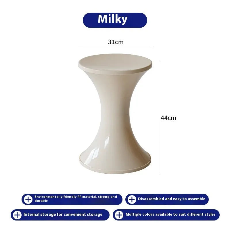 Plastic hourglass-shaped shoe changing stool in selected colour, shown in a home entryway setting.