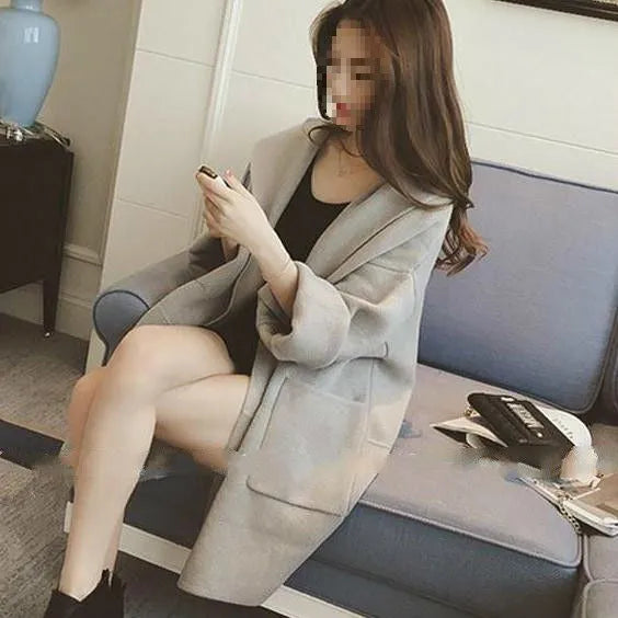 Plus size woman wearing a thin grey cotton coat with lace detail, loose fit, and long sleeves.