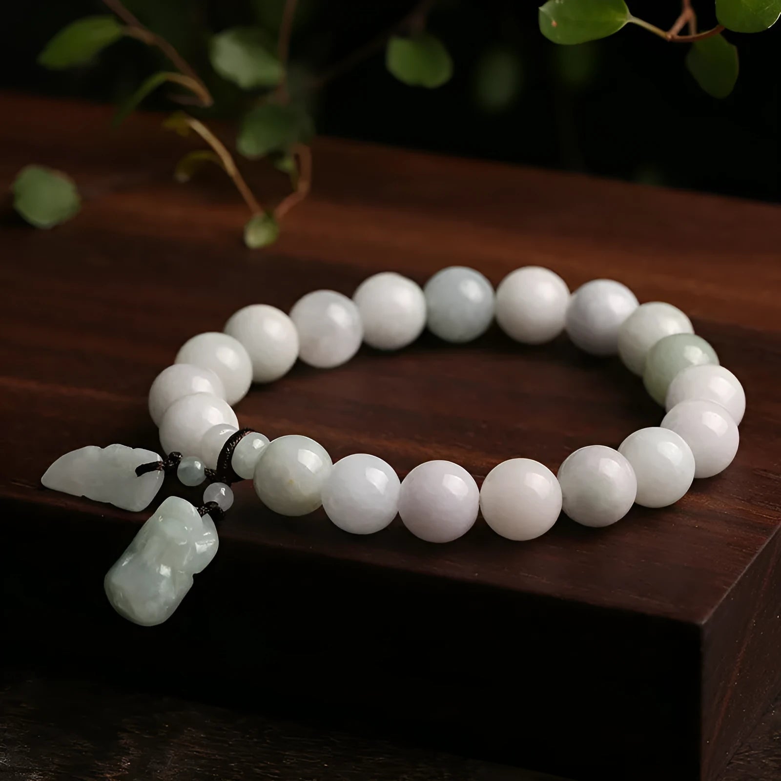 Natural green jade bracelet with geometric links and a carved Maitreya Buddha pendant.