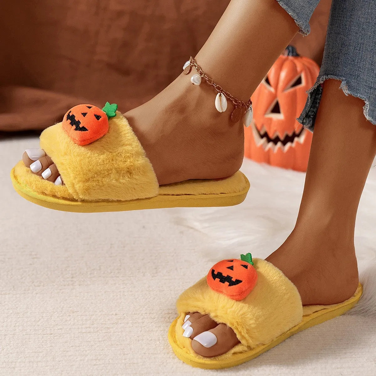 White and yellow Halloween cartoon pumpkin plush open-toe slippers with anti-slip PVC soles.