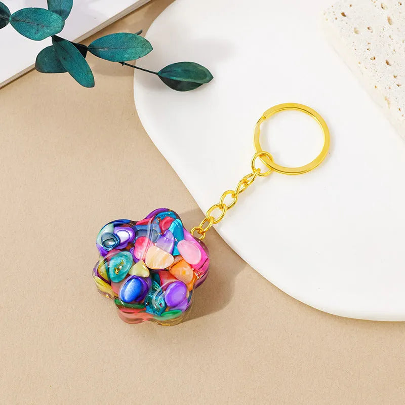 Natural crystal cat's paw keychain pendant in assorted gemstone colours on a keyring.