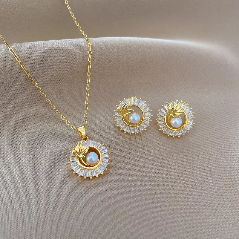 Women's titanium steel jewellery set with geometric leaf design necklace and matching earrings