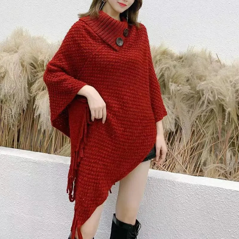 Women's triangular plush shawl cape in a cashmere blend with tassel detailing.